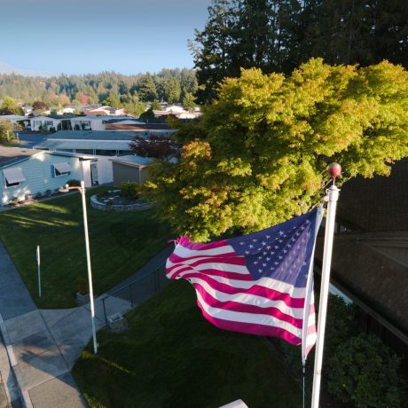 Park Village aerial view of US flag and homes